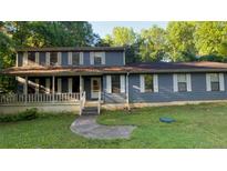 Charming two-story home with large front porch and a traditional architectural style at 145 Huntcliff Ct, Fayetteville, GA 30214