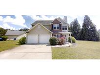 Charming two-story home with vinyl siding, a brick facade, a two-car garage, and well-maintained landscaping at 4884 Antelope Cv, Atlanta, GA 30349