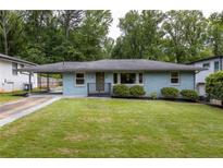 Charming single-story home featuring a well-maintained lawn and covered parking at 2274 Edgemore Se Dr, Atlanta, GA 30316