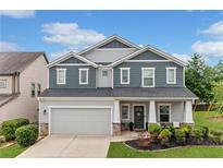 Beautiful two-story home featuring a manicured lawn and a two-car garage at 100 Grove View Rd, Woodstock, GA 30189