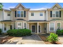 Charming townhome featuring a well-manicured front yard and inviting entrance at 2465 Brianna Dr, Hampton, GA 30228