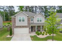 Charming two-story home with brick accents and a well-maintained landscaped front yard at 688 Saffron Blvd, Lawrenceville, GA 30045