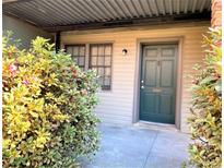 Charming front entrance with a dark teal door framed by lush greenery and a welcoming walkway at 3079 Colonial Way # J, Atlanta, GA 30341