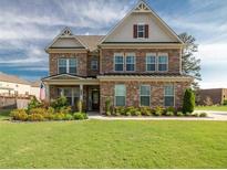 Charming two-story brick home with a well-manicured lawn and inviting curb appeal at 4790 Epps Ln, Cumming, GA 30040