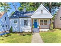 Charming home with a welcoming front porch, blue door, and well-manicured lawn at 1673 Richland Sw Rd, Atlanta, GA 30311