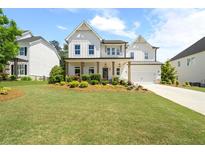 Beautiful two-story home with a manicured lawn and charming front porch at 3525 Brynhurst Dr, Cumming, GA 30028