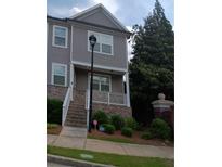 Two-story home with a brick foundation, steps to the front porch, and gray siding at 3242 Cascade Parc Sw Blvd, Atlanta, GA 30311