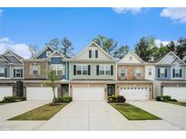 Attractive row of townhomes featuring varied exterior finishes and well-maintained landscaping at 2140 Ravencliff Dr, Austell, GA 30168