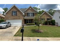 Charming two-story brick home with a well-manicured lawn and a two-car garage in a desirable neighborhood at 4952 Terrace Dr, Ellenwood, GA 30294
