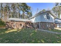 Charming two-story home with a brick facade and well-maintained front lawn at 1038 Seven Springs Cir, Marietta, GA 30068