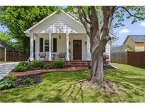 Charming home featuring a landscaped yard and welcoming front porch with brick steps and seating area at 94 Glenn Se St, Atlanta, GA 30312