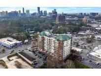 Stunning aerial view of a condo building nestled in a vibrant urban setting with breathtaking city skyline views at 3820 Roswell Ne Rd # 705, Atlanta, GA 30342