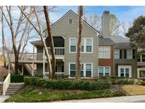 Charming two-story condo featuring a mix of brick and siding, with a chimney and covered balcony at 500 Bainbridge Dr, Atlanta, GA 30327