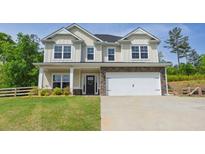 Charming two-story home with stone accents, a well-manicured lawn, and an attached two-car garage at 47 Whitley Ct, Dallas, GA 30157