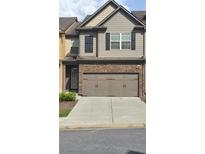 Charming two-story home features a two car garage and classic architectural details at 3456 Sardis Bend Dr, Buford, GA 30519