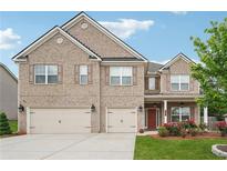 Beautiful brick two-story home with a three-car garage and well-maintained lawn at 3670 Casual Ridge Way, Loganville, GA 30052