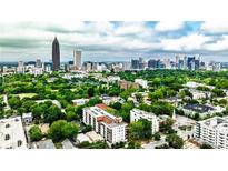Stunning aerial view of Atlanta's skyline with lush green trees and scattered buildings beneath a partly cloudy sky at 525 Parkway Dr # 218, Atlanta, GA 30354