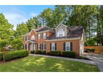Charming two-story brick home with lush landscaping and a well-manicured lawn in a desirable neighborhood at 5661 Fairwood Nw Dr, Acworth, GA 30101