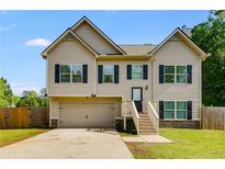 Charming two-story home with a well-manicured lawn, attached garage, and inviting front entrance at 119 Sourwood Lane, Temple, GA 30179