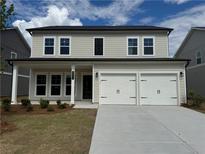 Charming two-story home featuring a welcoming front porch and a two-car garage at 2101 Boxwood Circle Se, Conyers, GA 30094