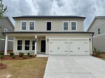 Charming two-story home with a two-car garage and well-manicured front lawn at 2101 Boxwood Circle Se, Conyers, GA 30094
