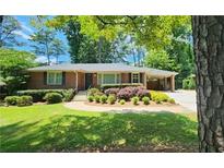 Charming one-story brick home with mature landscaping, a well-manicured lawn, and a convenient carport at 2132 Clairmont Rd, Brookhaven, GA 30033