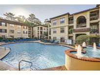 Resort-style pool with fountains and lounge chairs at a luxurious apartment complex with well-maintained landscaping at 3777 Peachtree Ne Rd # 412, Brookhaven, GA 30319