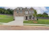 Charming two-story brick home featuring a well-manicured lawn and a two-car garage at 1109 Georgian Point Dr, Lawrenceville, GA 30045