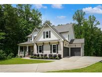 Beautiful two-story home with a well-manicured lawn, dark shutters and an attached two-car garage at 4383 Capstone Ne Ct, Roswell, GA 30075