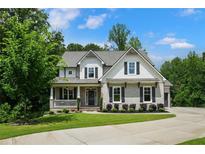 Charming two-story home with beautiful landscaping, symmetrical windows, and a welcoming front porch at 4383 Capstone Ne Ct, Roswell, GA 30075
