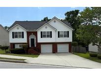 Charming two-story home with brick and white siding, two car garage, and well-maintained landscaping at 995 Chimney Trace Way, Lawrenceville, GA 30045