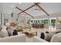 Bright open-concept living room with vaulted ceilings, exposed beams, and natural light at 605 Ga 120 Hwy, Roswell, GA 30075
