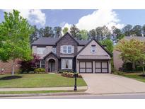 Charming two-story home with a manicured lawn, stone accents, and a two-car garage, creating a welcoming curb appeal at 2720 Garonne Way, Cumming, GA 30041