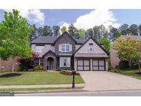 Beautiful two-story home featuring a landscaped yard and an attached two-car garage at 2720 Garonne Way, Cumming, GA 30041