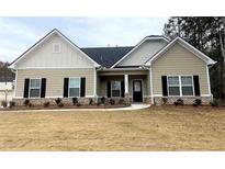 Charming single-story home featuring black shutters and a well-manicured lawn in a quiet neighborhood at 100 Ruby Ln, Mcdonough, GA 30252