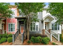 Charming townhomes with stone accents, landscaped front yards, and inviting staircases leading to covered entryways at 3642 Princeton Ave, Atlanta, GA 30337