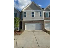 Two-story home featuring a brick facade and a two-car garage with a modern architectural design at 7621 Gray Pointe Dr, Lithonia, GA 30058
