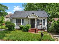 Charming home featuring gray shutters, landscaped bushes, and a cozy front porch at 1377 Pine Ave, Atlanta, GA 30344