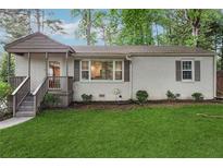 Charming single-story home with painted brick, cozy front porch, and well-maintained lawn at 2586 Valley Stream Dr, Atlanta, GA 30360