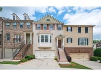 Charming townhome showcasing brick facade, well-maintained landscaping, and convenient garage access at 4306 Laurel Creek Se Ct, Smyrna, GA 30080