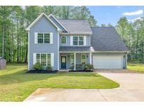 Charming two-story home featuring a two-car garage and a beautifully manicured lawn at 5652 Burruss Rd, Cumming, GA 30028