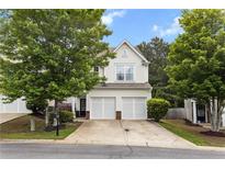 Charming two-story home with a two-car garage and well-maintained landscaping and mature trees at 720 Mountain Laurel Dr, Canton, GA 30114