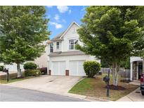 Charming two-story home with a two-car garage, well-manicured lawn, and mature trees at 720 Mountain Laurel Dr, Canton, GA 30114
