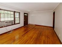 Inviting living room with hardwood floors, natural light, and neutral paint at 1025 Cheaves St, Forest Park, GA 30297