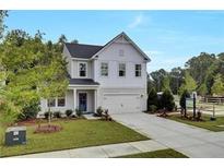 Charming two-story home boasts a manicured lawn, inviting entrance, and a convenient two-car garage at 516 Altamaha Ct, Locust Grove, GA 30248
