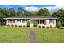 Charming brick home with manicured lawn, blue shutters, and lush landscaping at 175 Brookhaven Dr, Marietta, GA 30066