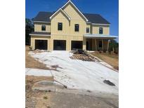 Newly constructed home features a three-car garage and covered front porch at 222 Silvercrest Dr, Acworth, GA 30101