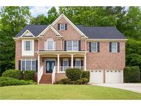 Charming brick home with a well-manicured lawn and a two-car garage at 1382 Benbrooke Nw Ln, Acworth, GA 30101