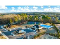 Stunning aerial view of community pool, tennis courts, and clubhouse at Water Oak Estates at 1831 Lacebark Elm Way, Lawrenceville, GA 30045