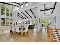 Bright, open dining room featuring high ceilings, black beam accents, and a large table with seating for eight at 3165 Brookview Dr, Marietta, GA 30068